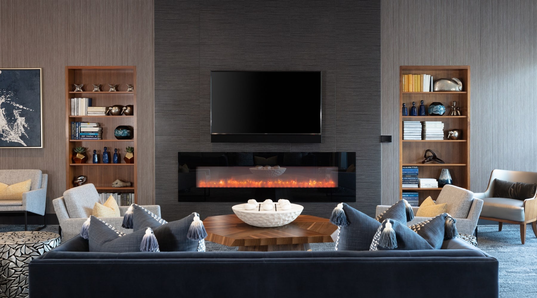 spacious lounge area with brick accents and a fireplace