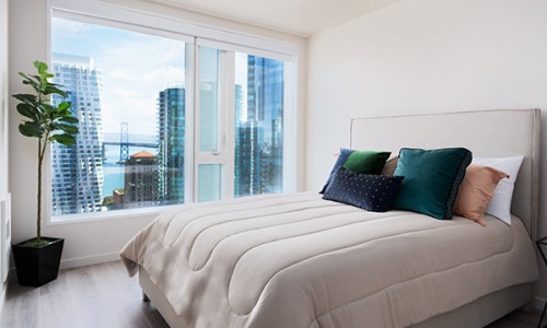 picture window with city views brightens bedroom
